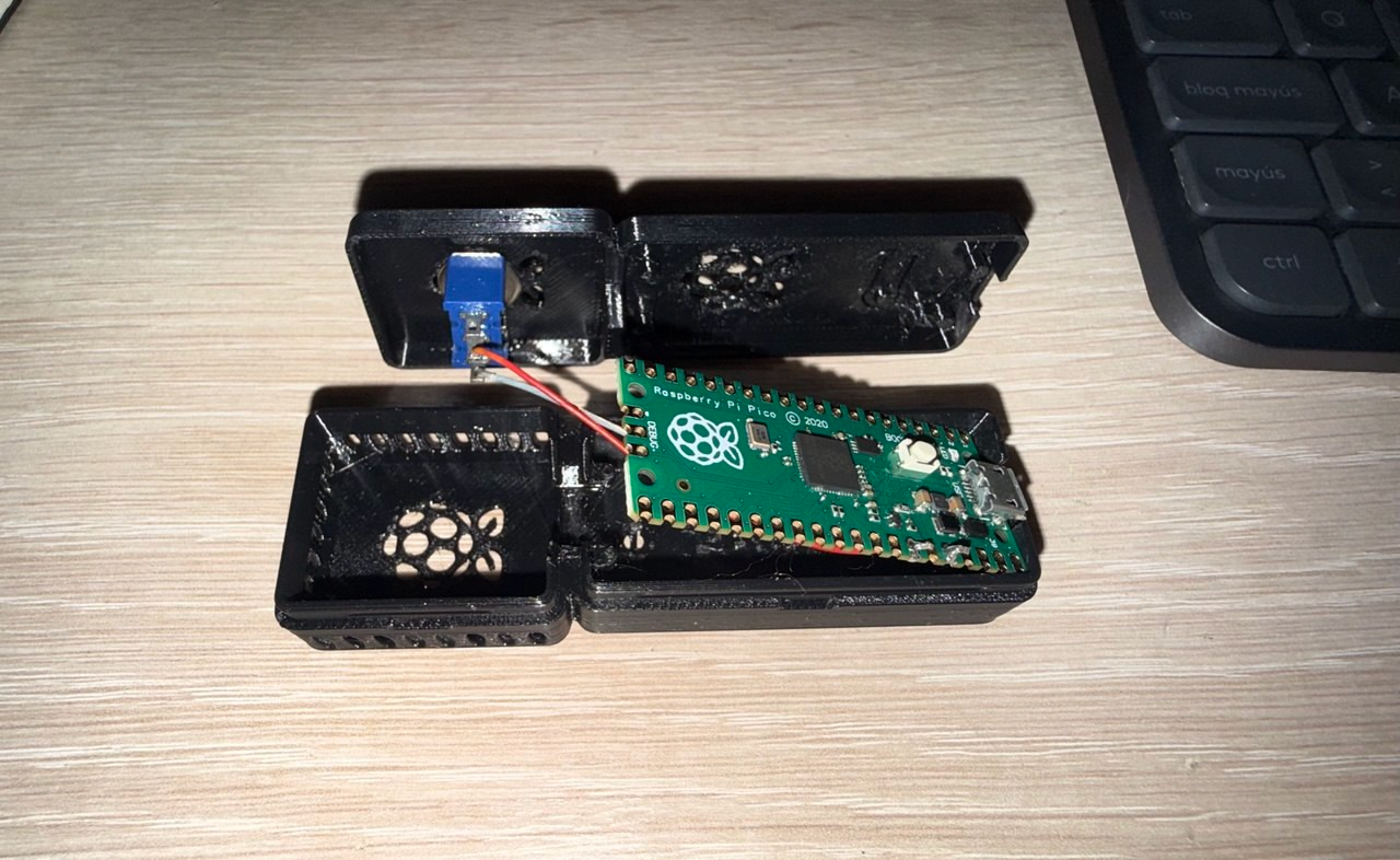 Close-up teardown with the Pico seated and wired to the switch